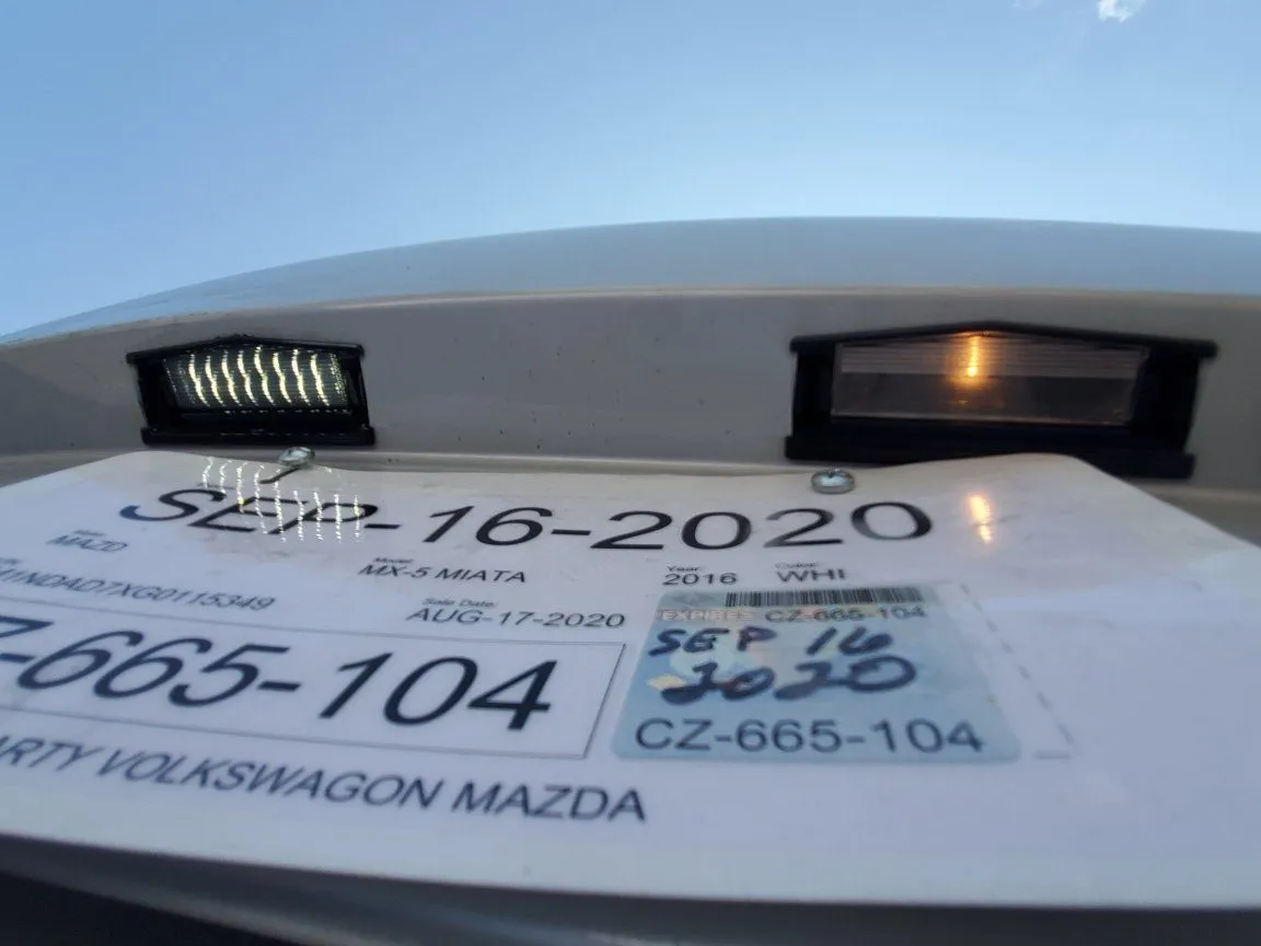 Ghost - CarbonMiata Smoked LED License Plate Light vs OEM Lit.jpeg