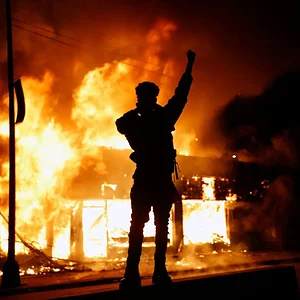 A check-cashing business burns during protests in Minneapolis on Friday.webp