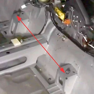 Inner drivers seat rail attachment points without carpet.webp