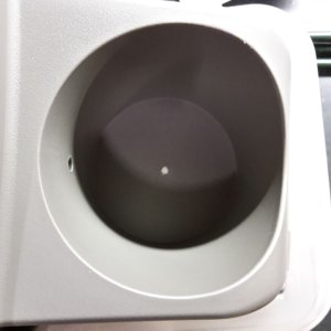 Hole in the bottom of the cupholder to secure the power socket.jpg