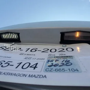 Ghost - CarbonMiata Smoked LED License Plate Light vs OEM Lit.jpeg