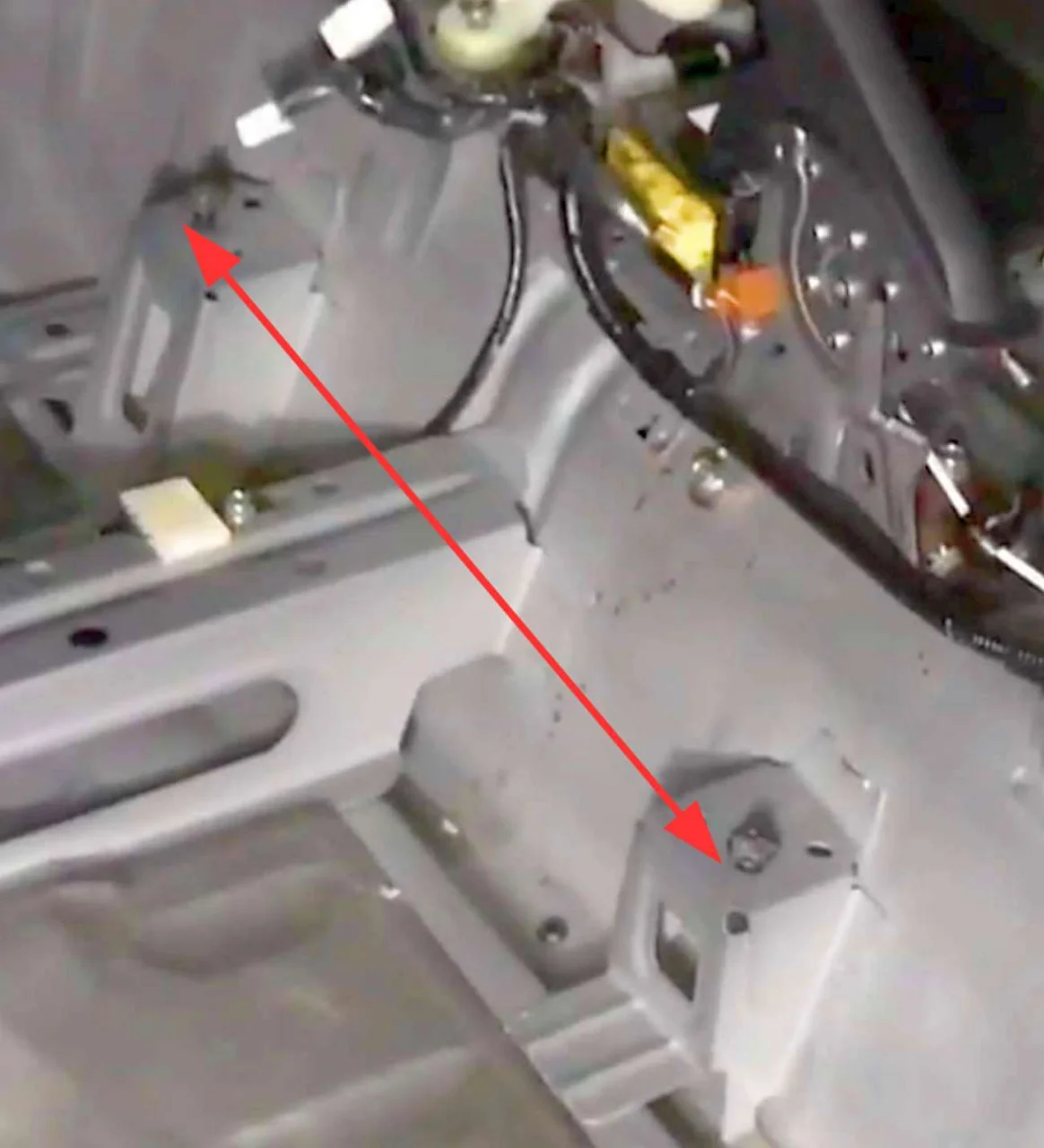 Inner drivers seat rail attachment points without carpet.webp