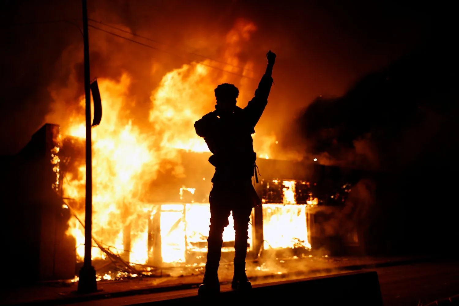A check-cashing business burns during protests in Minneapolis on Friday.webp