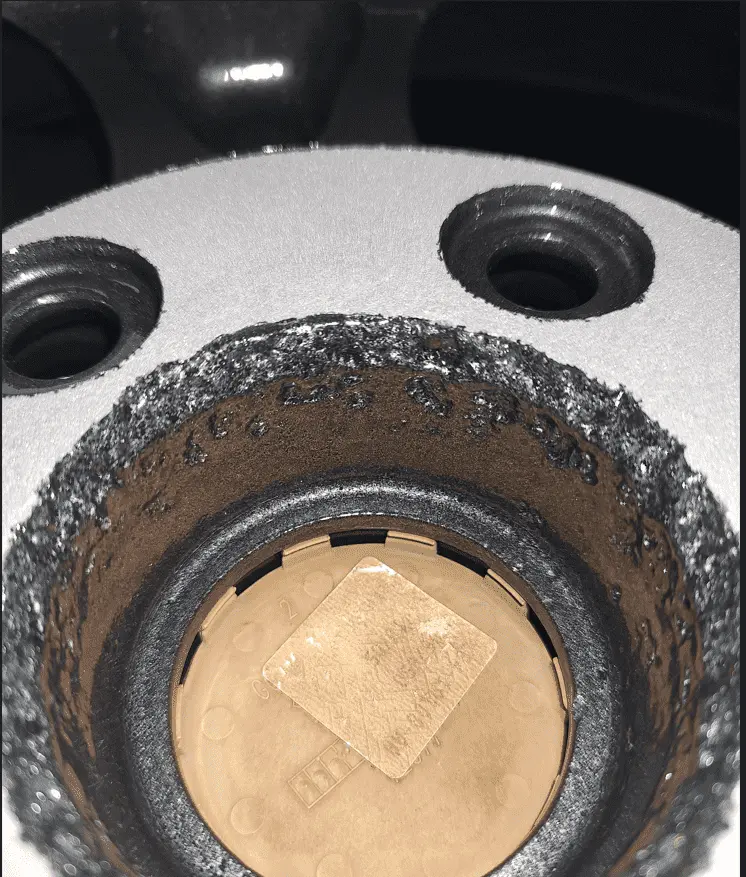 mazda wheel deeply gouged by sandblast.png