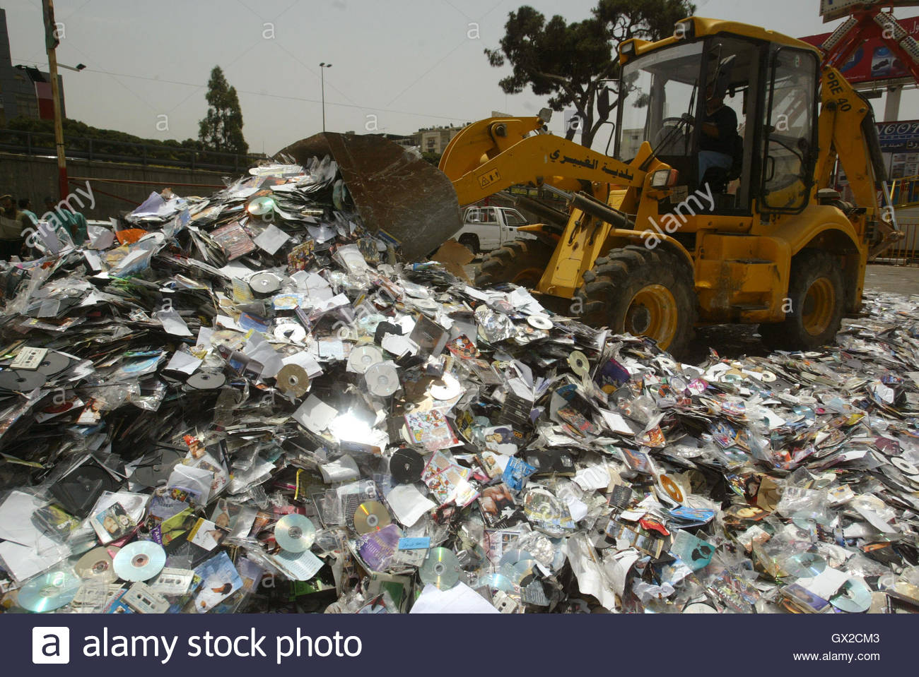 a-bulldozer-destroys-a-pile-of-pirated-cds-and-dvds-that-were-confiscated-GX2CM3.jpg